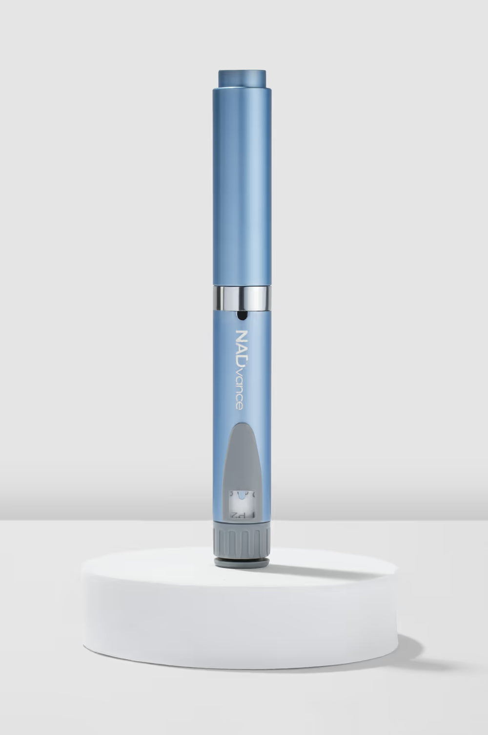 Blue electronic device on a white pedestal with a light gray background  NAD+Vance Pen